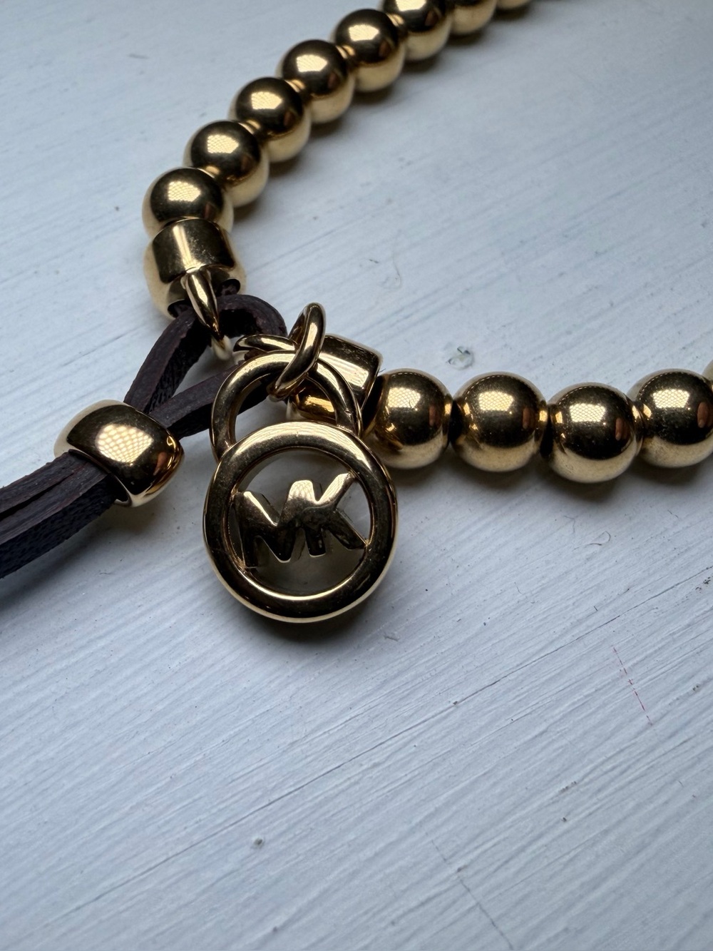 Michael Kors Gold Beaded Bracelet with MK Charm and Brown Leather Accent